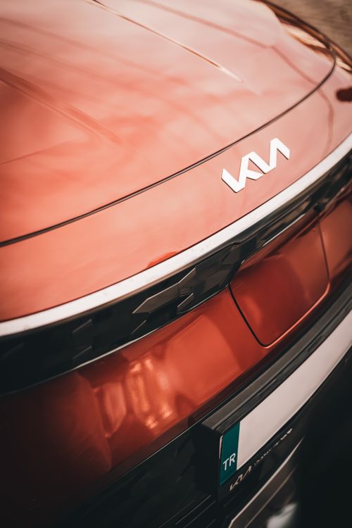 Free Stylish close-up of a red Kia vehicle's rear, showcasing the new logo design. Stock Photo