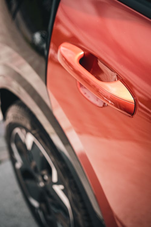 Scratched Handle of a Red Door of a Car