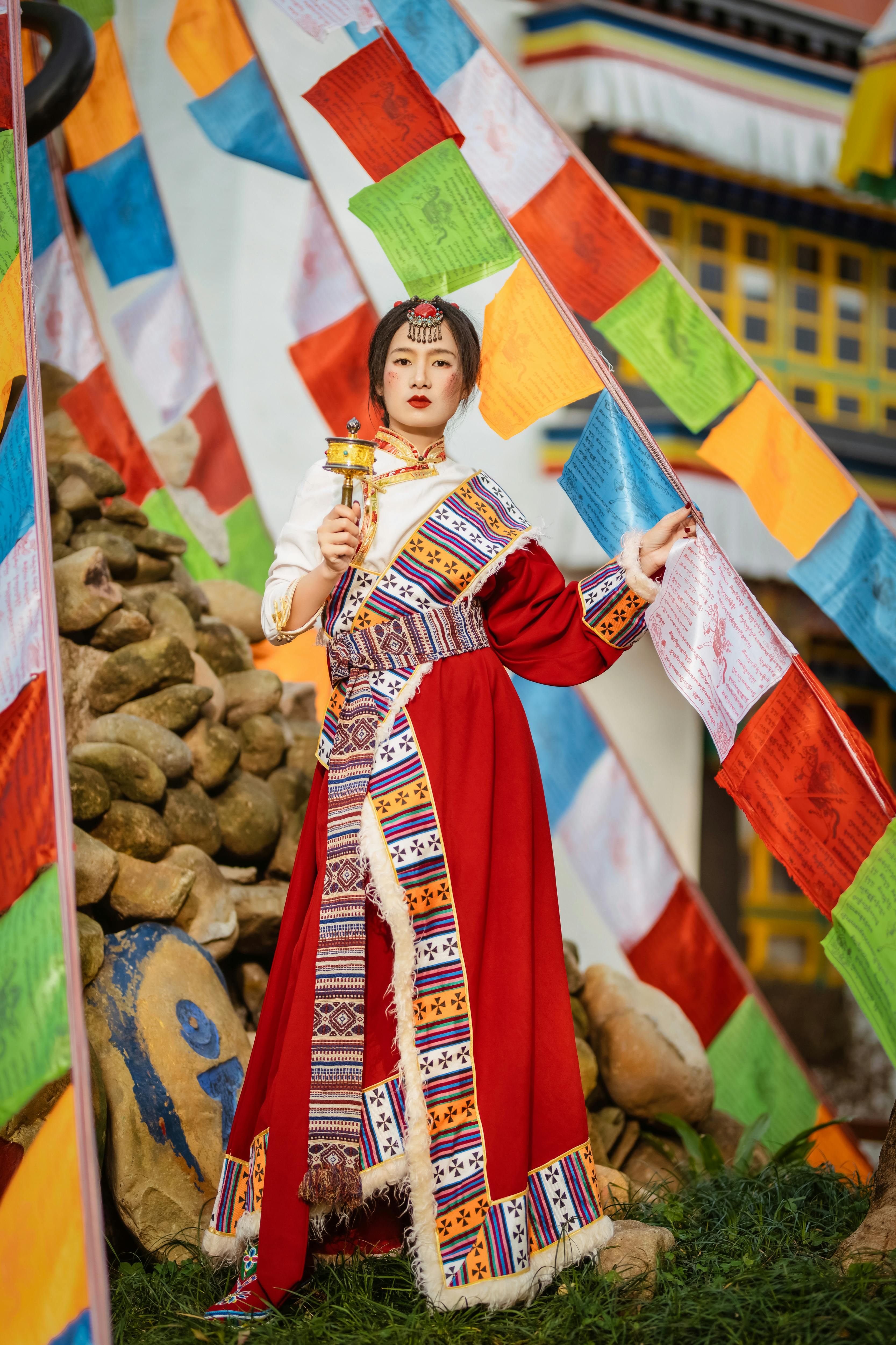 woman in traditional clothing among colorful decorations