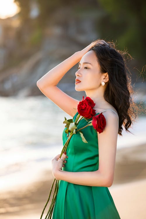 Woman in Green Dress Posing with Roses
