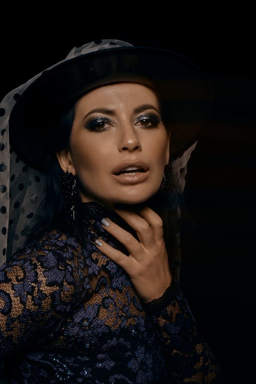 Elegant Woman in a Hat and Lace Blouse 