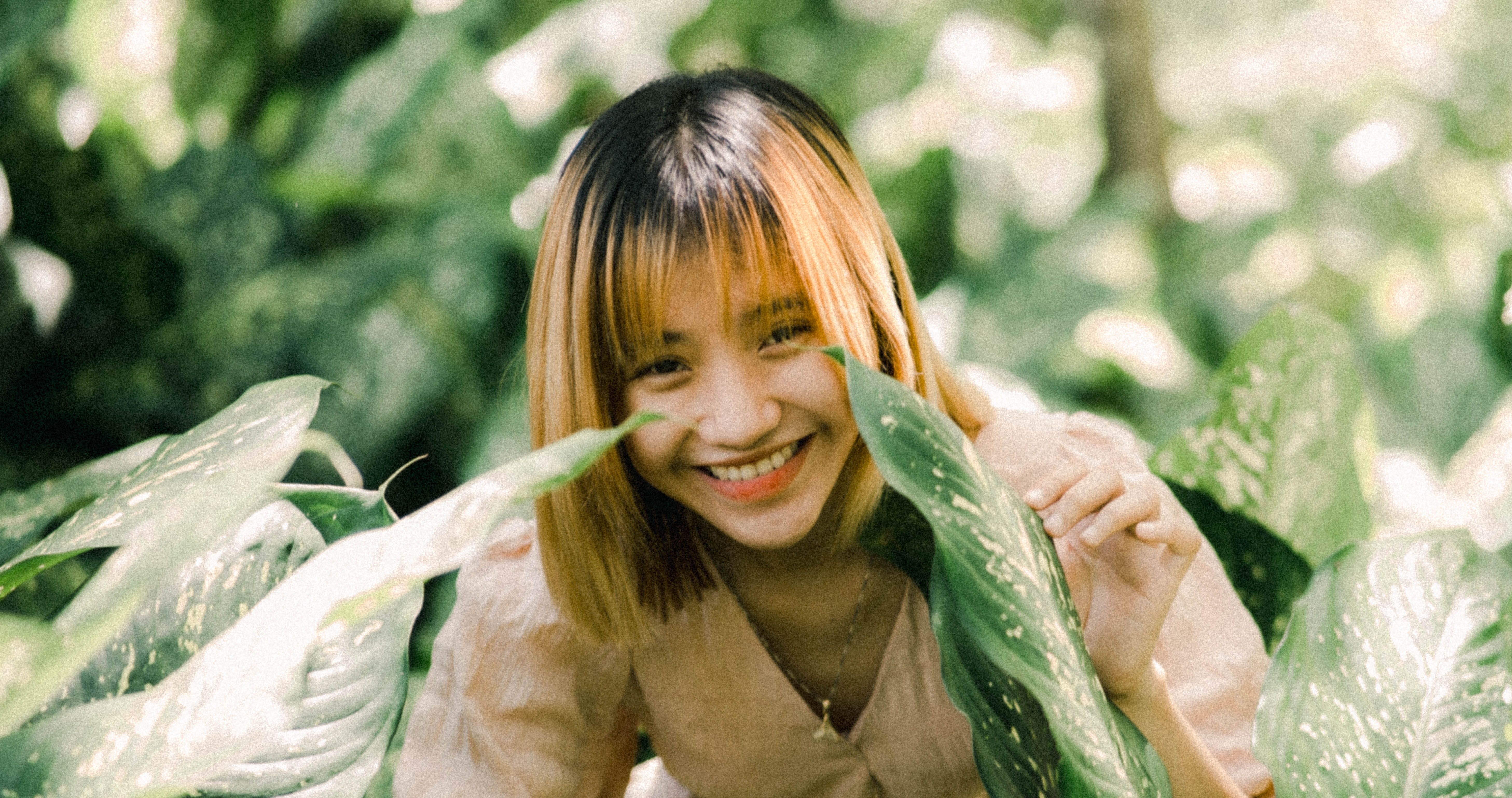 Smiling Woman Posing with Leaves · Free Stock Photo