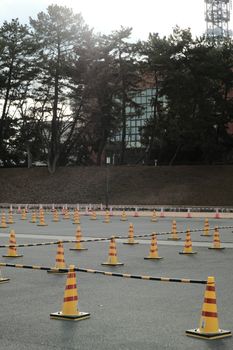 Photo by Mak_ jp Outdoor driving course with traffic cones setup for training and practice.