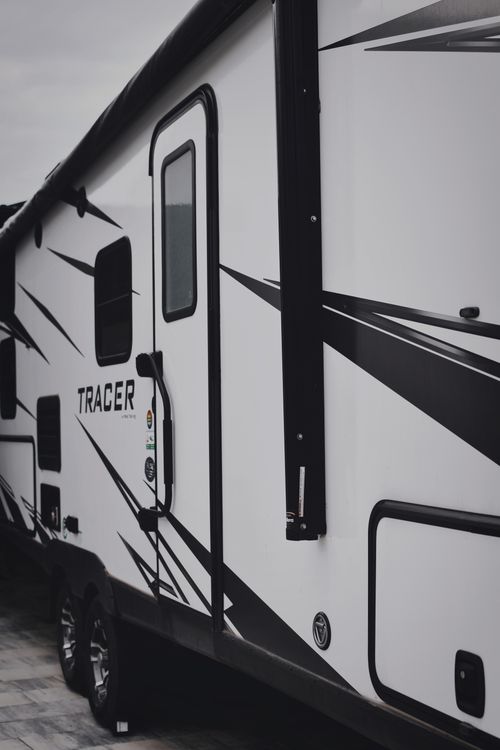 Free Stylish black and white camper van for travel and vacation exploration. Stock Photo