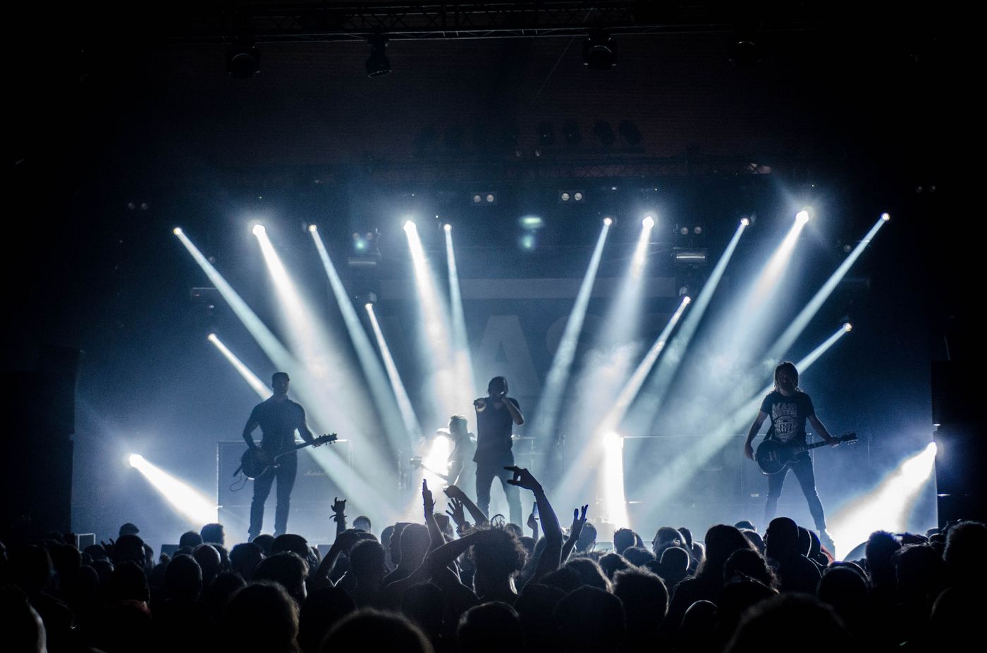Lead guitarist lit by concert spotlights