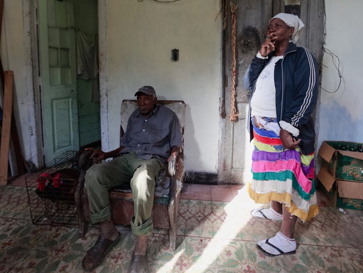 Elderly Woman And Man Near House