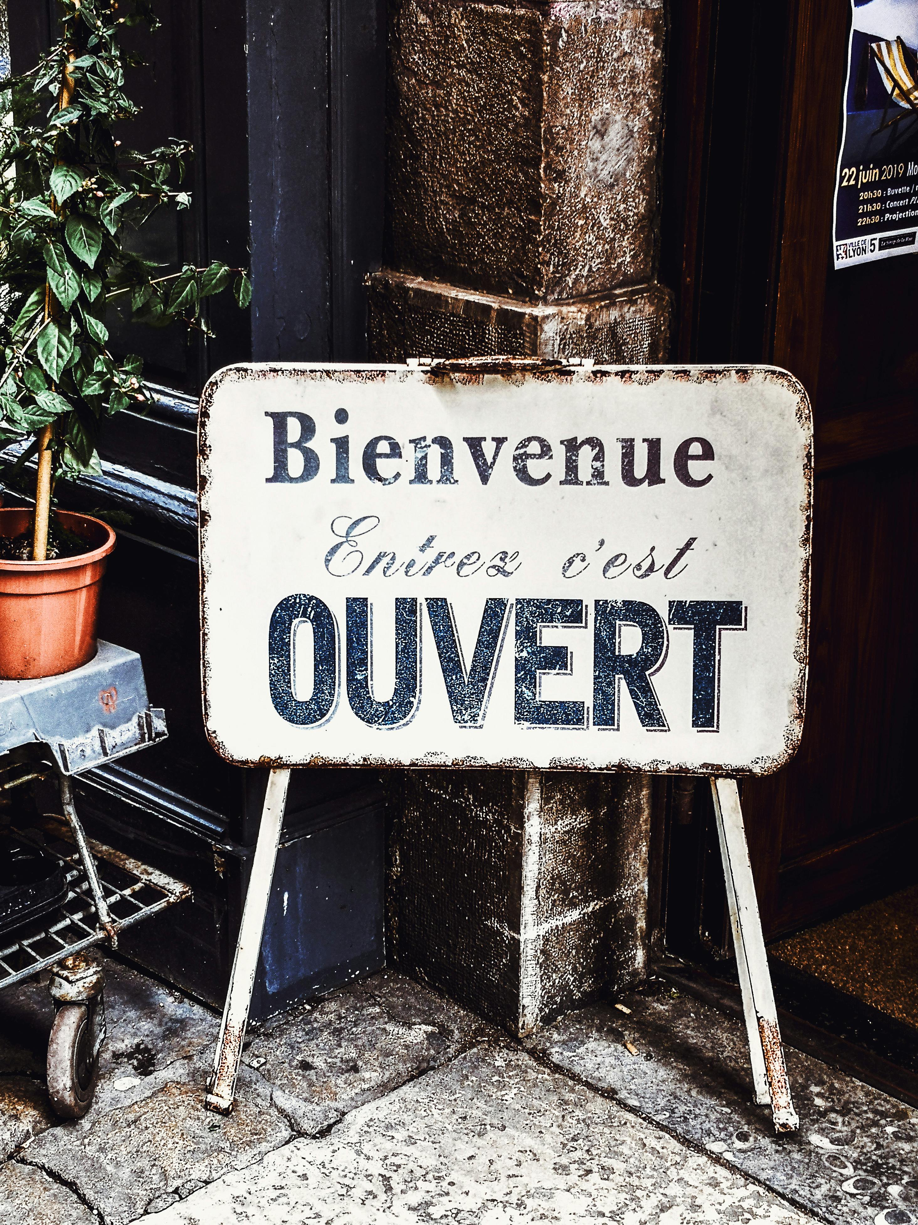 Outdoor Open Sign With Written In It In French Ouvert, Bienvenue Meaning  In English Open, Welcome. Stock Photo, Picture and Royalty Free Image.  Image 151867173.