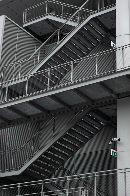 Free Vertical shot of a modern metal staircase with industrial design in an urban environment. Stock Photo