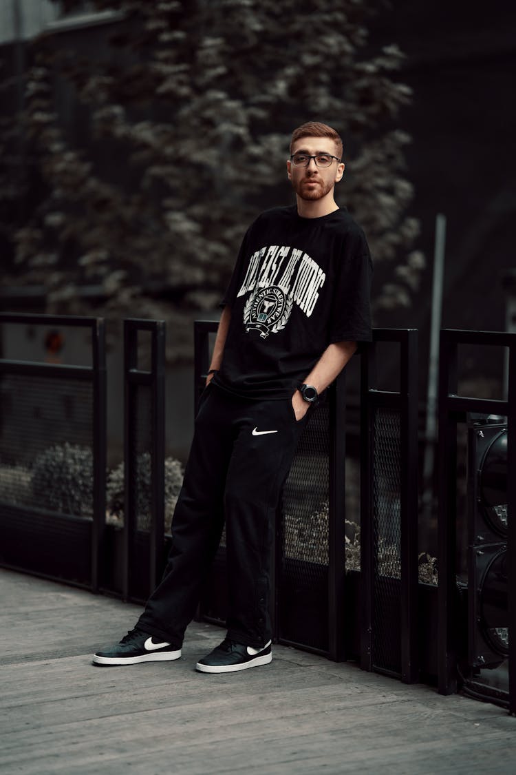 Man Wearing Black Clothes On A Wooden Bridge 