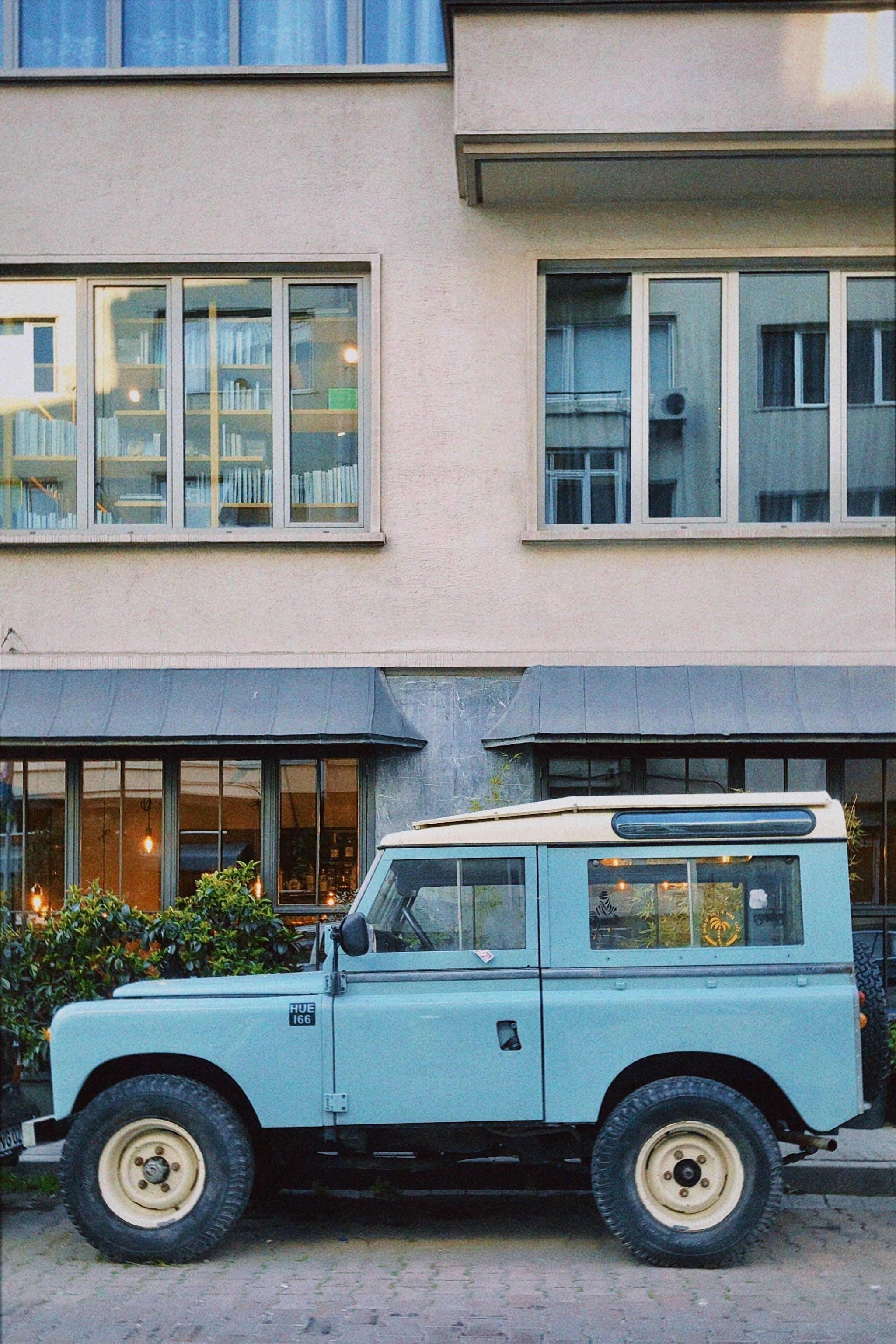 A Vintage Blue Land Rover Truck Parked in City · Free Stock Photo