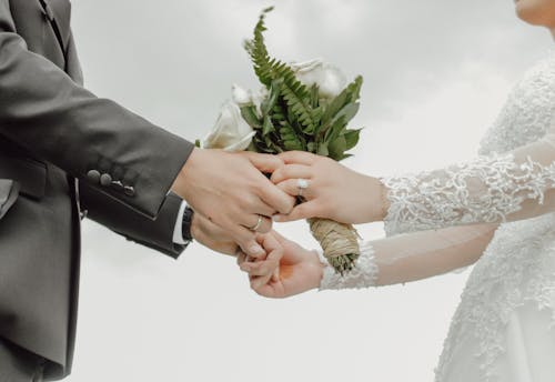 Close up of Newlyweds Holding Bouquet Together