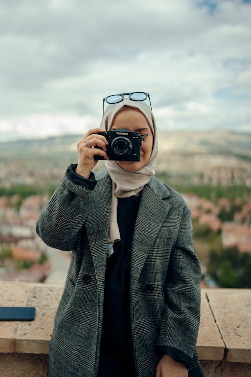 Woman in Coat Posing with Camera