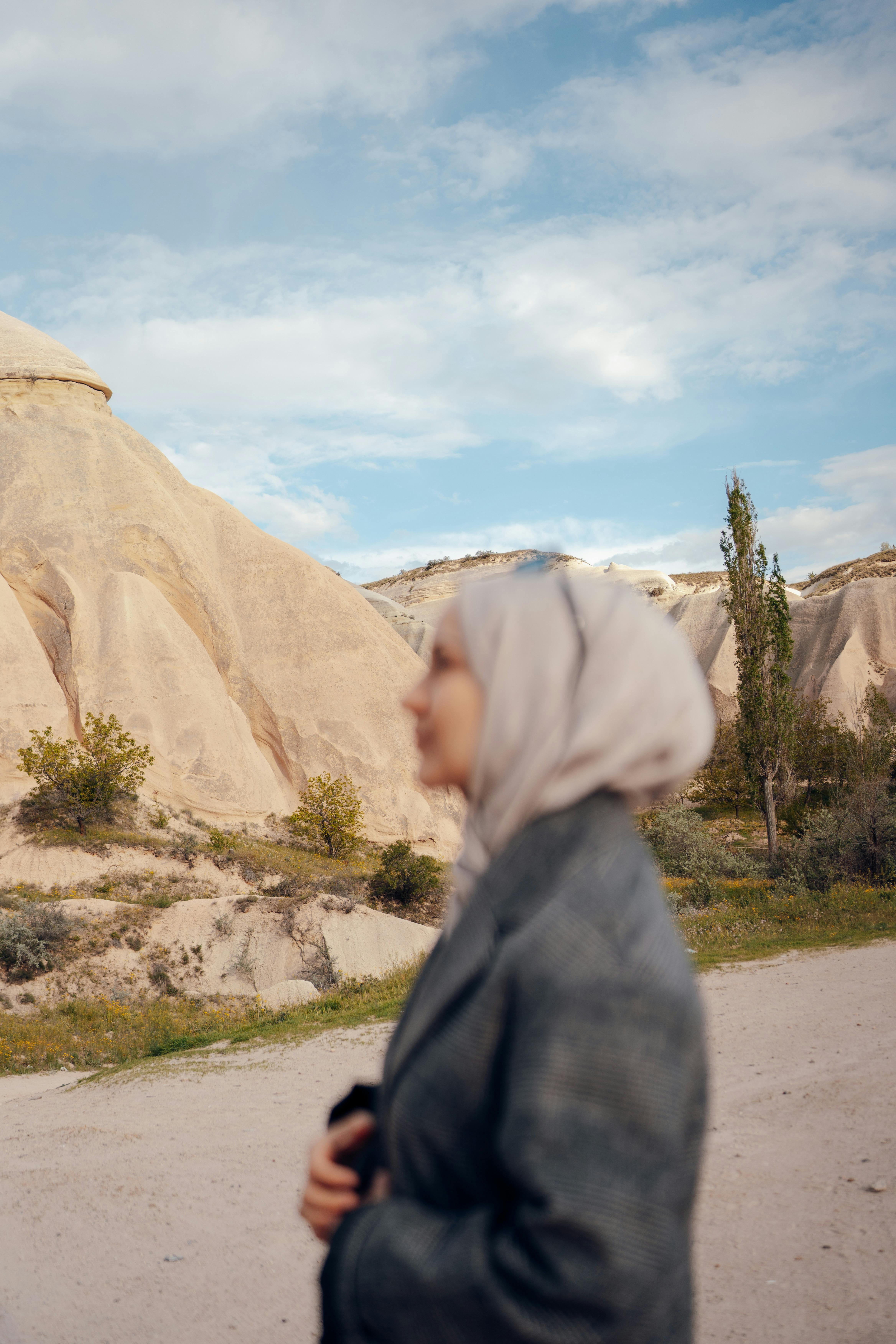 Woman in Hijab with Rock Formation behind · Free Stock Photo