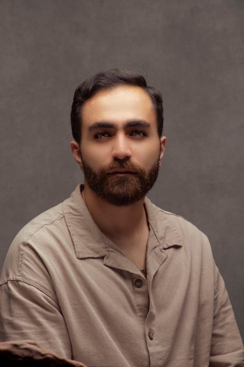 Free Elegant studio portrait of a bearded man with a neutral background. Stock Photo