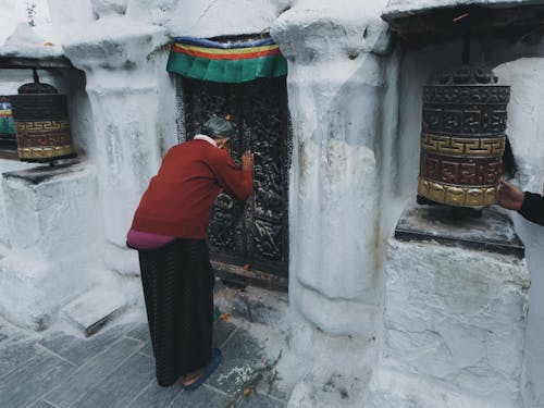 Woman Praying by Buddhist Temple