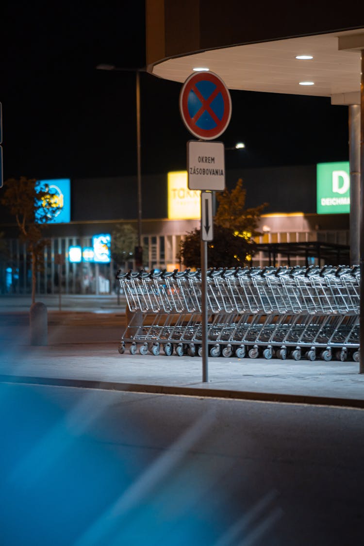 Row Of Shopping Carts By A Supermarket At Night