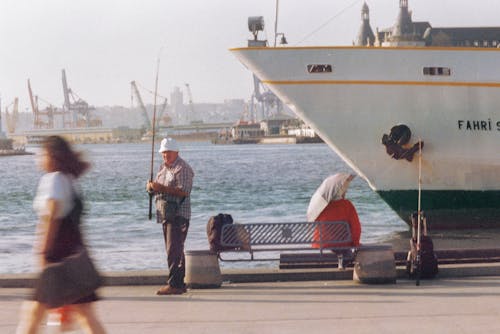 Angler with Fishing Rod in Harbor