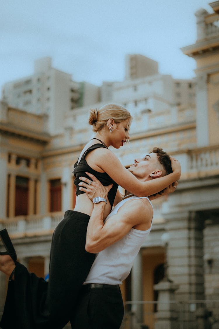 Man Holding Up A Woman