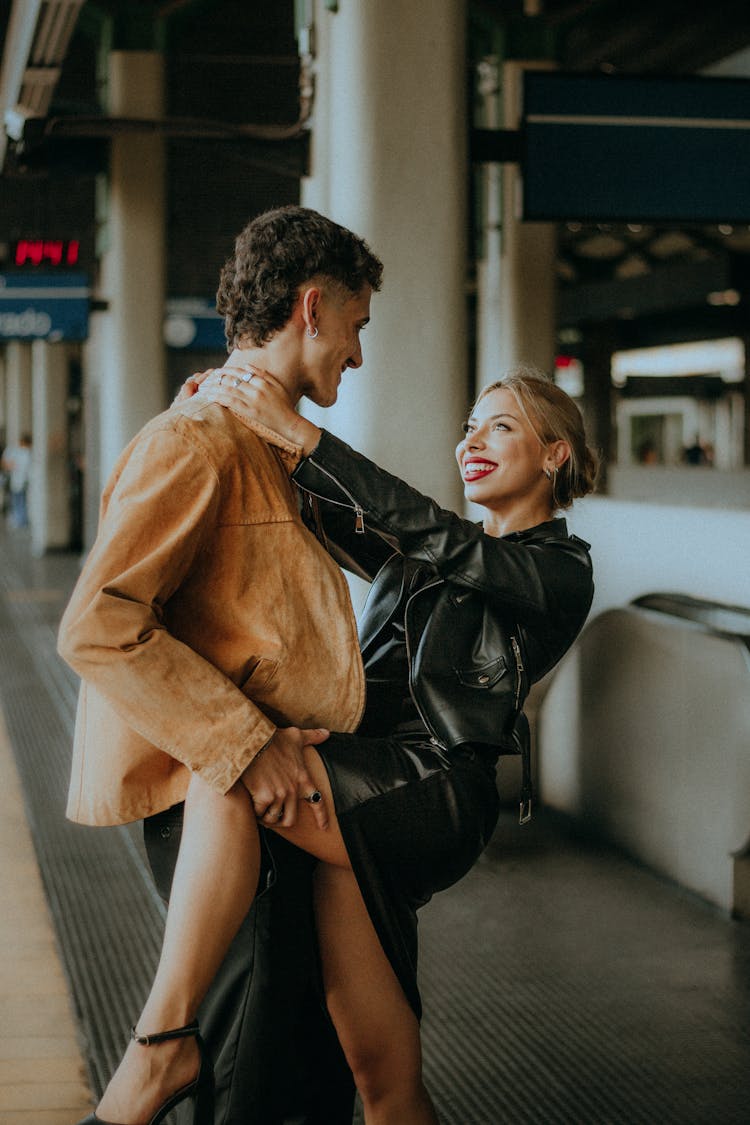 Smiling Woman Holding Leg On Mans Hip