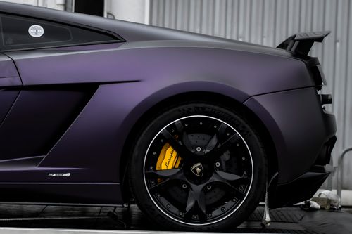 Free Matte purple Lamborghini Gallardo close-up on brake disc and wheel. Powerful supercar design. Stock Photo