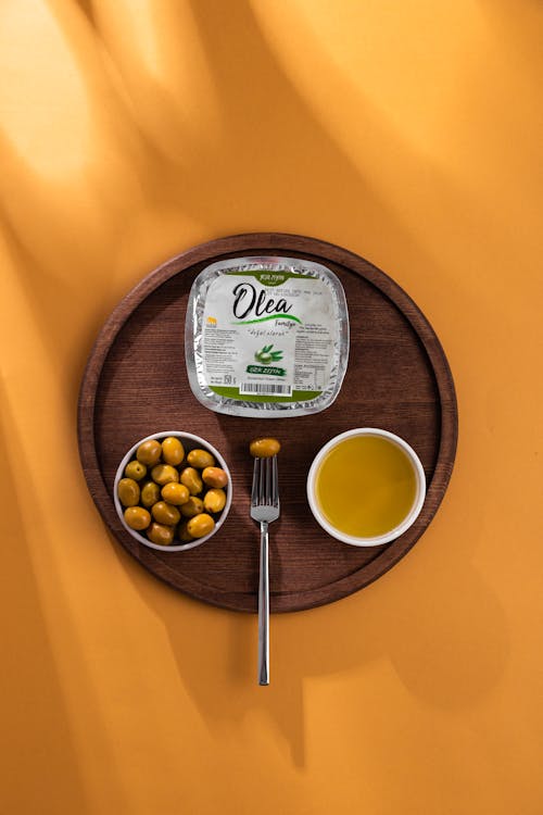 Olives and Fork on Wooden Plate