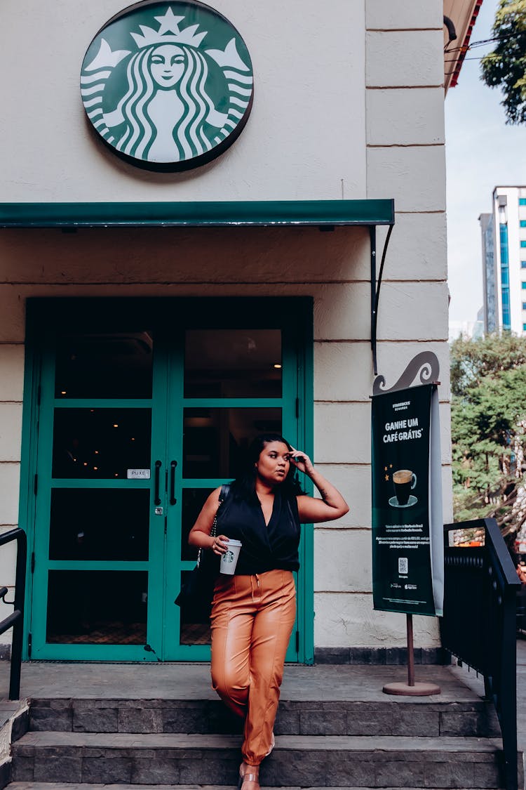 Woman Leaving Starbucks Cafe