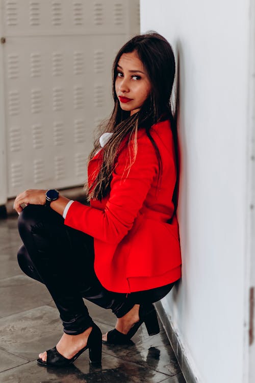 Brunette Woman Squatting in Red Suit