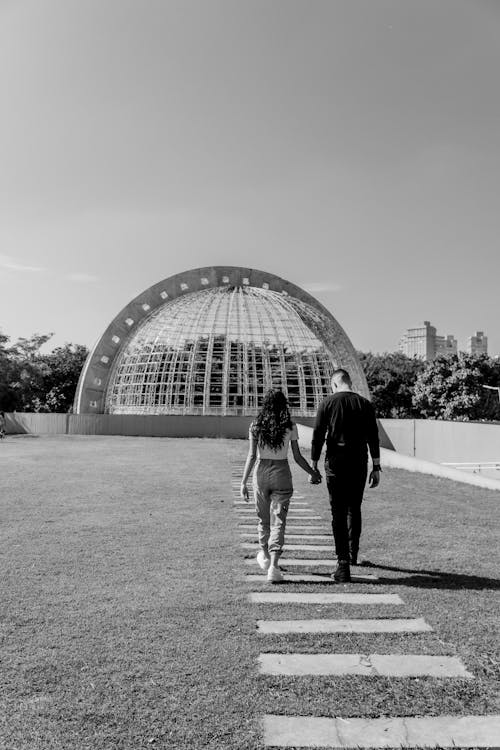 Couple Holding Hands and Walking Together in Black and White