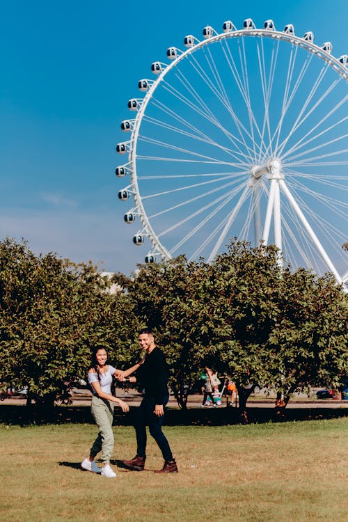 Couple Posing in Park with London Eye behind