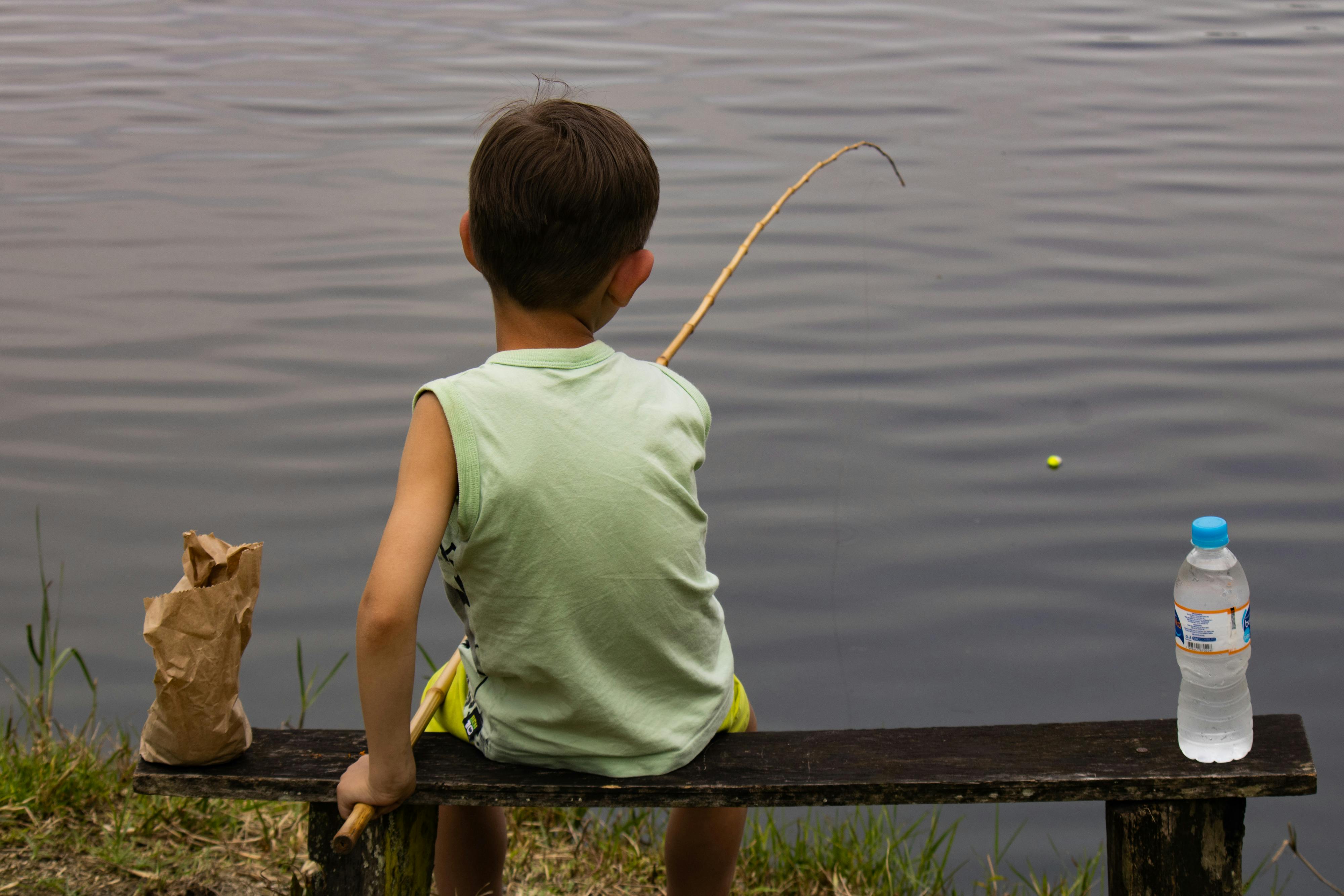 Boy Fishing with Wooden Fishing Rod · Free Stock Photo