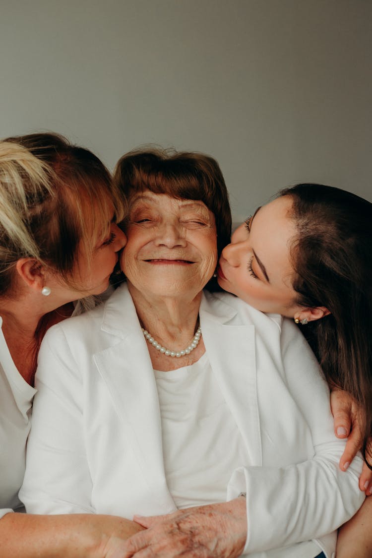 Mother And Daughter Kissing Grandma