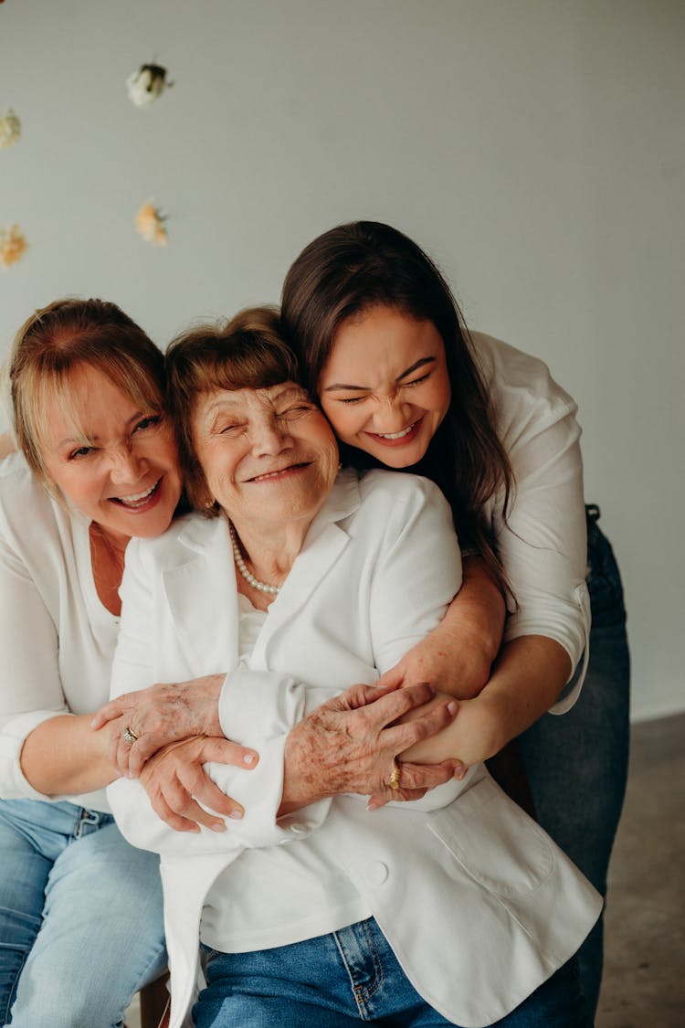 Mother And Daughter Hugging Grandma