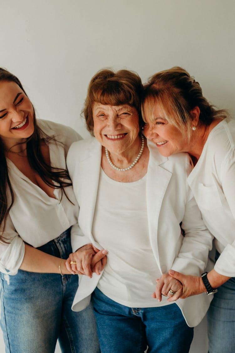 Grandma, Mother And Daughter Smiling And Holding Hands