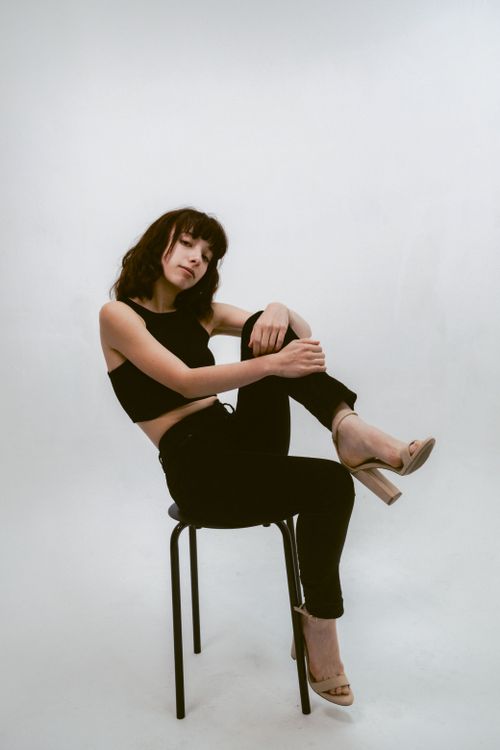 Free Creative fashion portrait of a woman in a chic pose, embracing edgy and modern style. Stock Photo