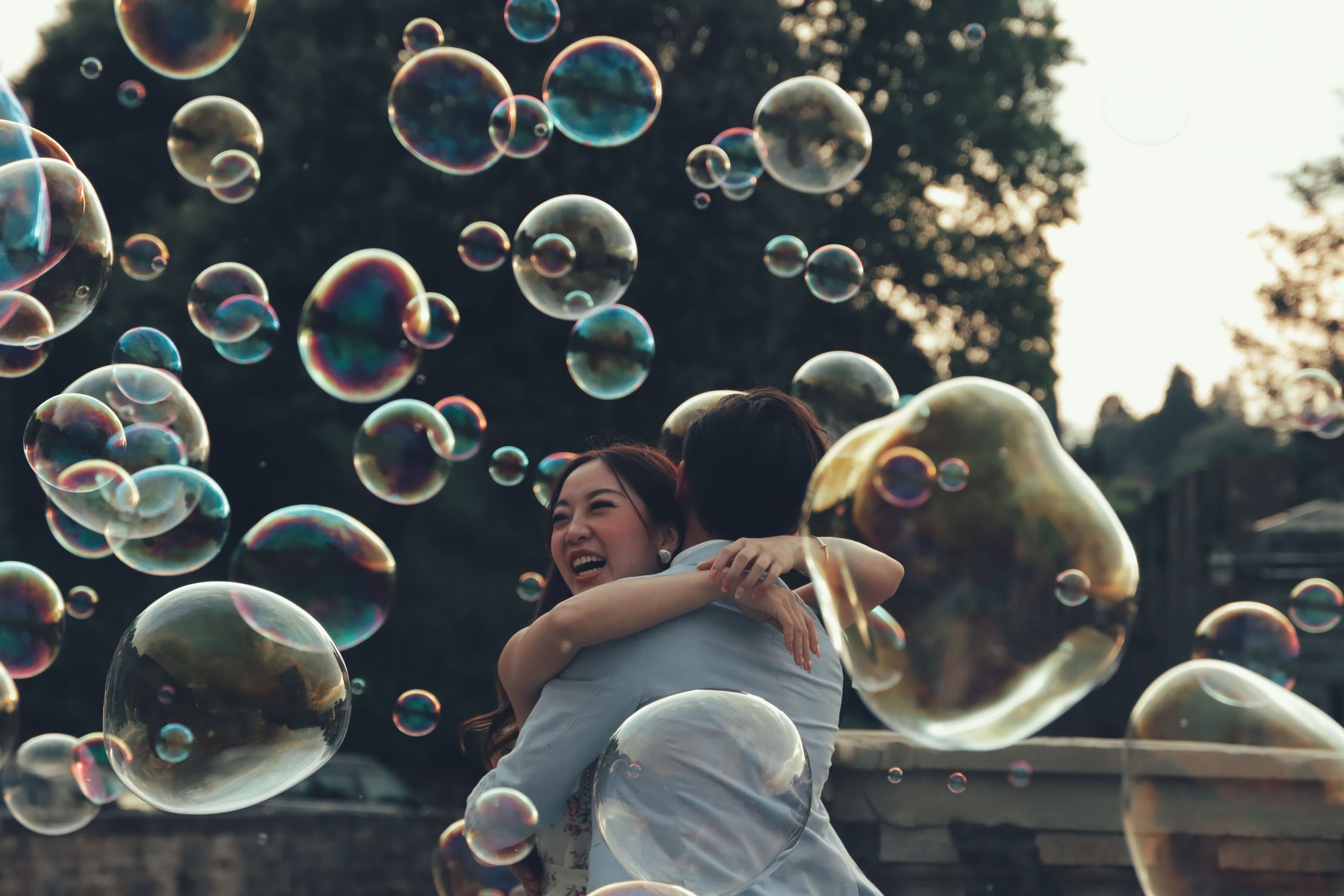 Bubbles Flying over Hugging Couple · Free Stock Photo