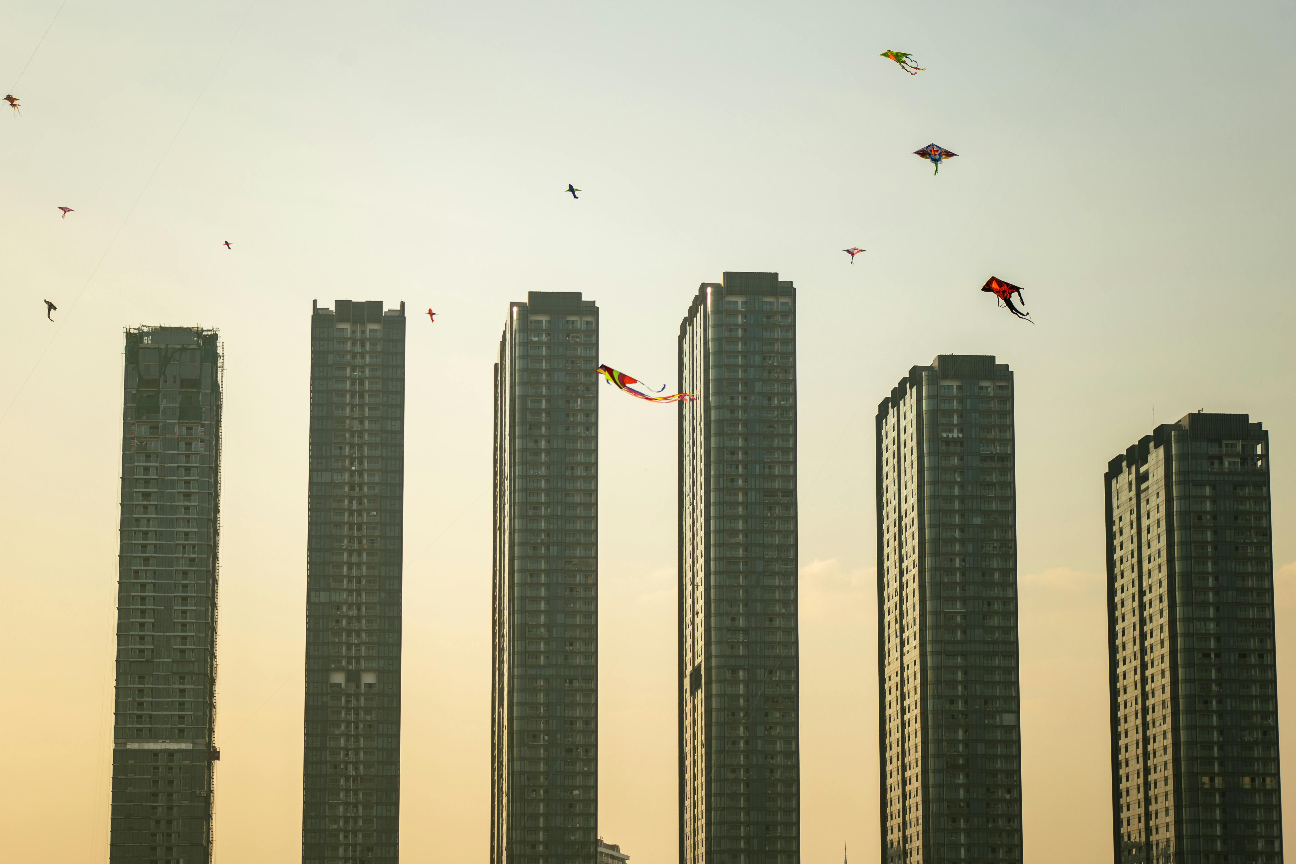 A serene view of skyscrapers with colorful kites in the sky over Ho Chi Minh City, Vietnam.