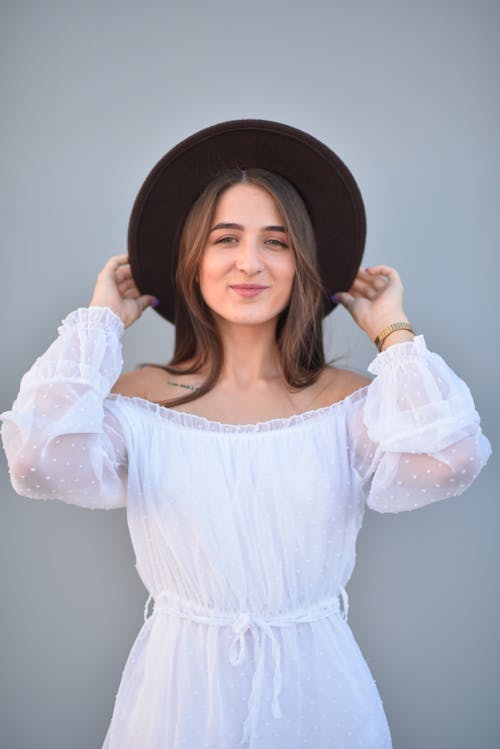 Young Woman in a White Dress and a Hat 