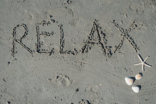 Word Relax Written in Sand on the Beach 