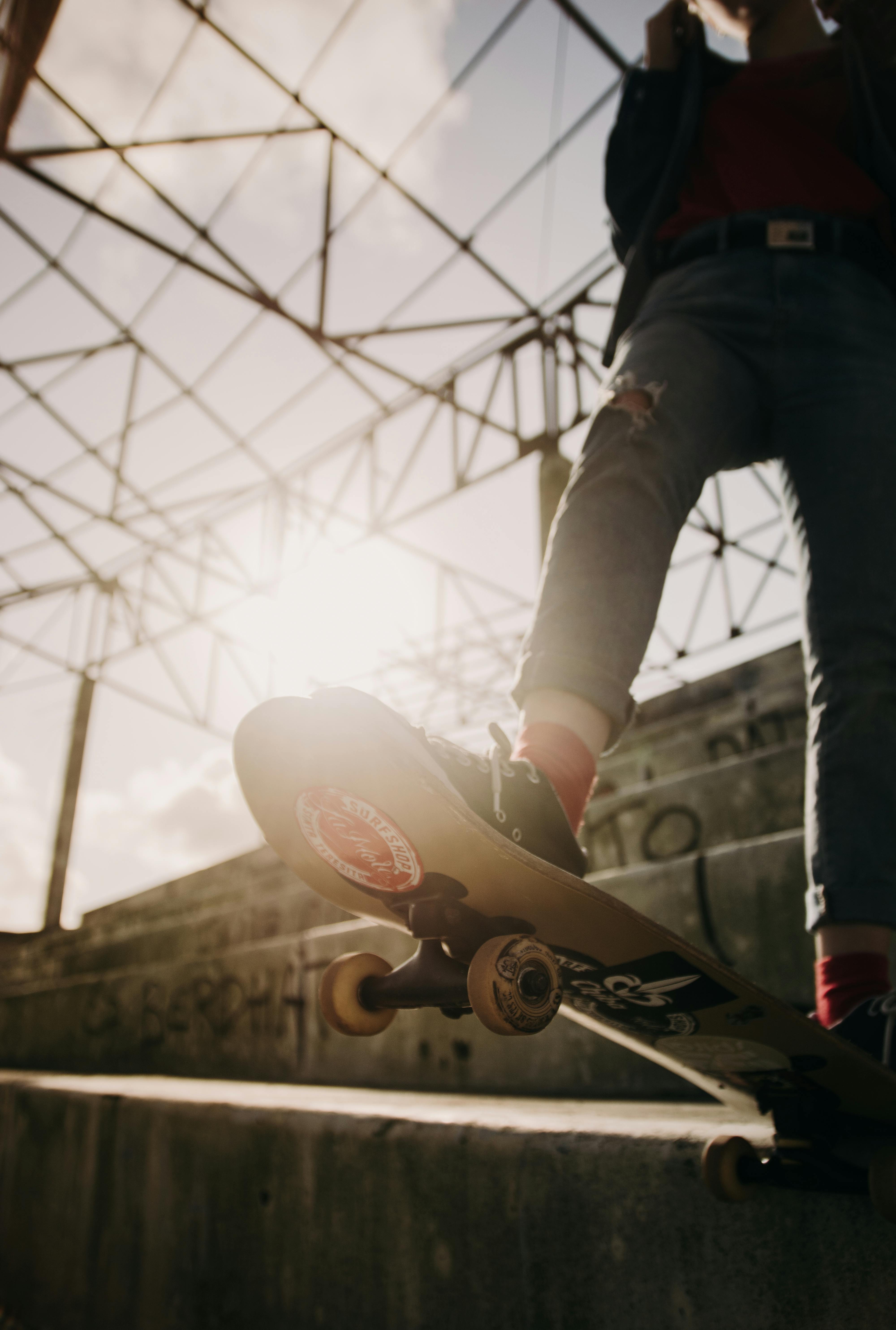 Sunlight over Legs of Person on Skateboard · Free Stock Photo