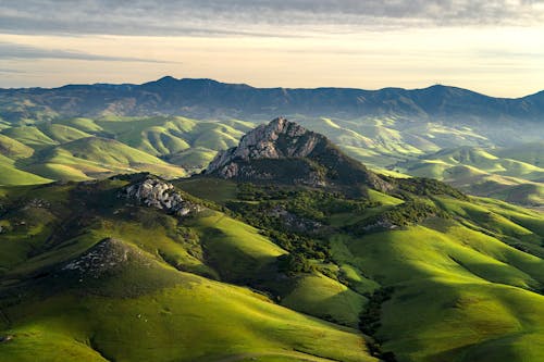 Scenic View of Green Hills and Mountains 