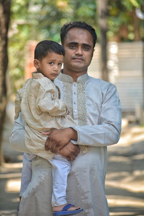 Man in Traditional Clothing Posing with Son