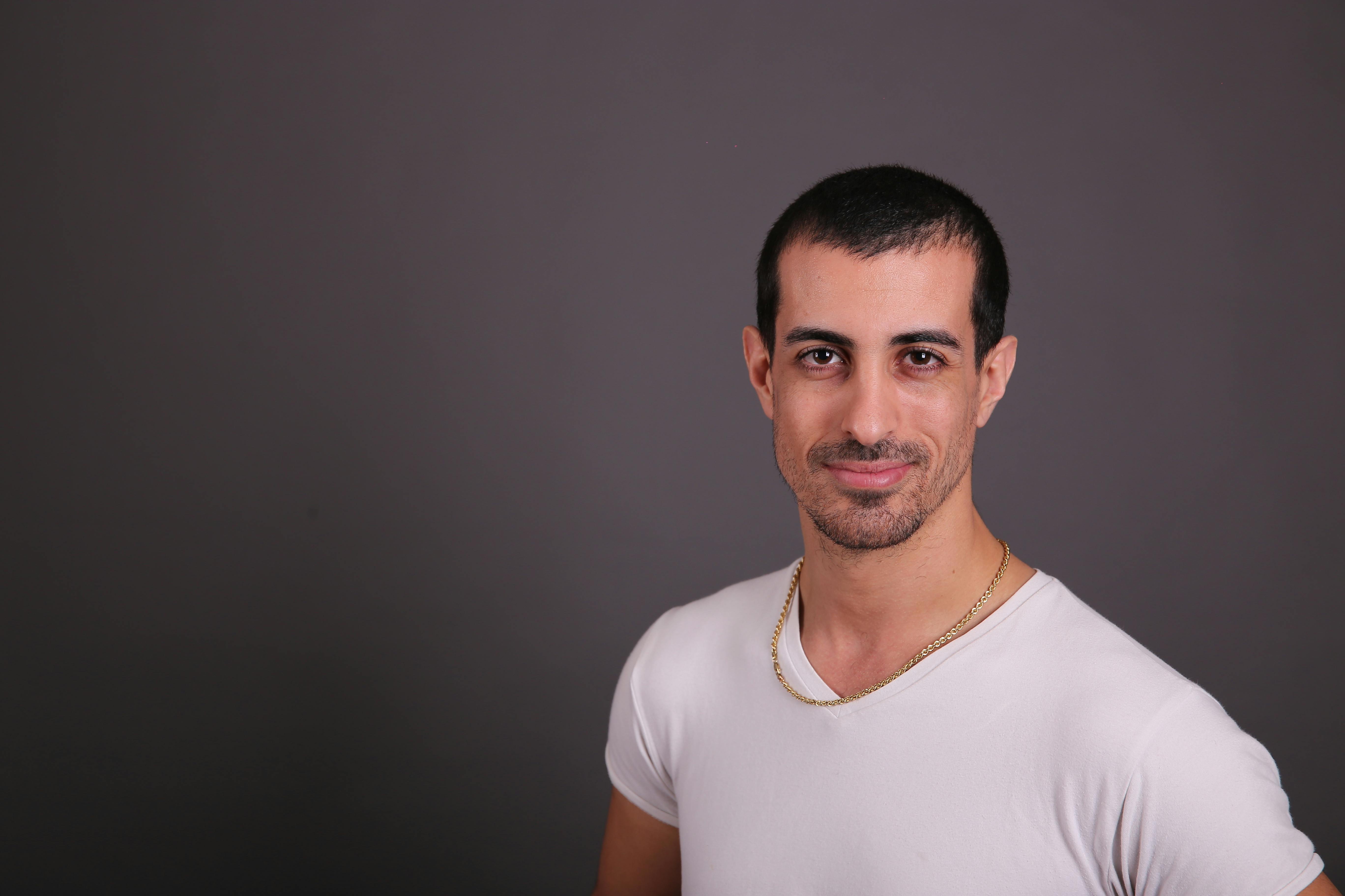 a man in a white shirt posing for a photo