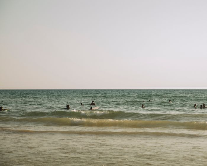 Swimmers in the sea at dusk, photo by joao Guerreiro on Pexels