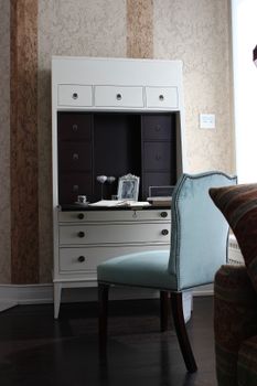 A stylish office space featuring a modern dresser and armchair, ideal for interior design inspiration.