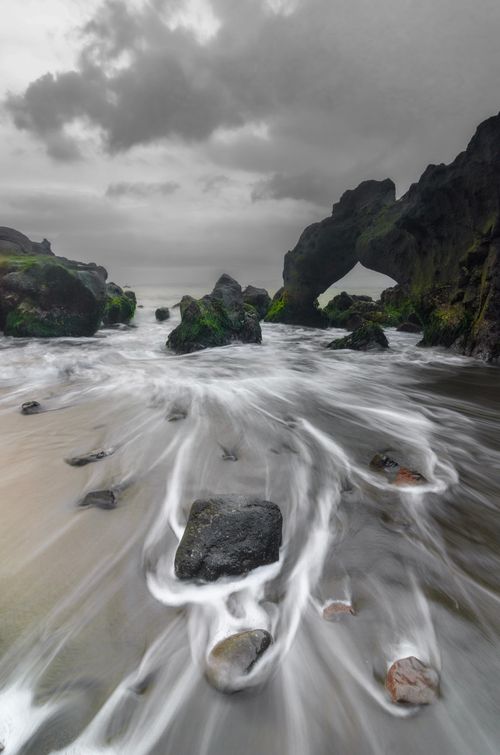 Free Long exposure shot of a rocky beach in Jawa Barat, Indonesia, with dramatic waves and clouds. Stock Photo
