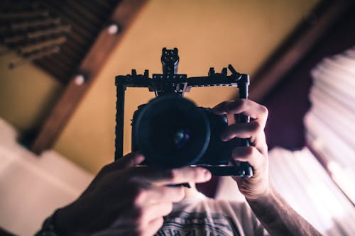 Person Holding Black Dslr Camera