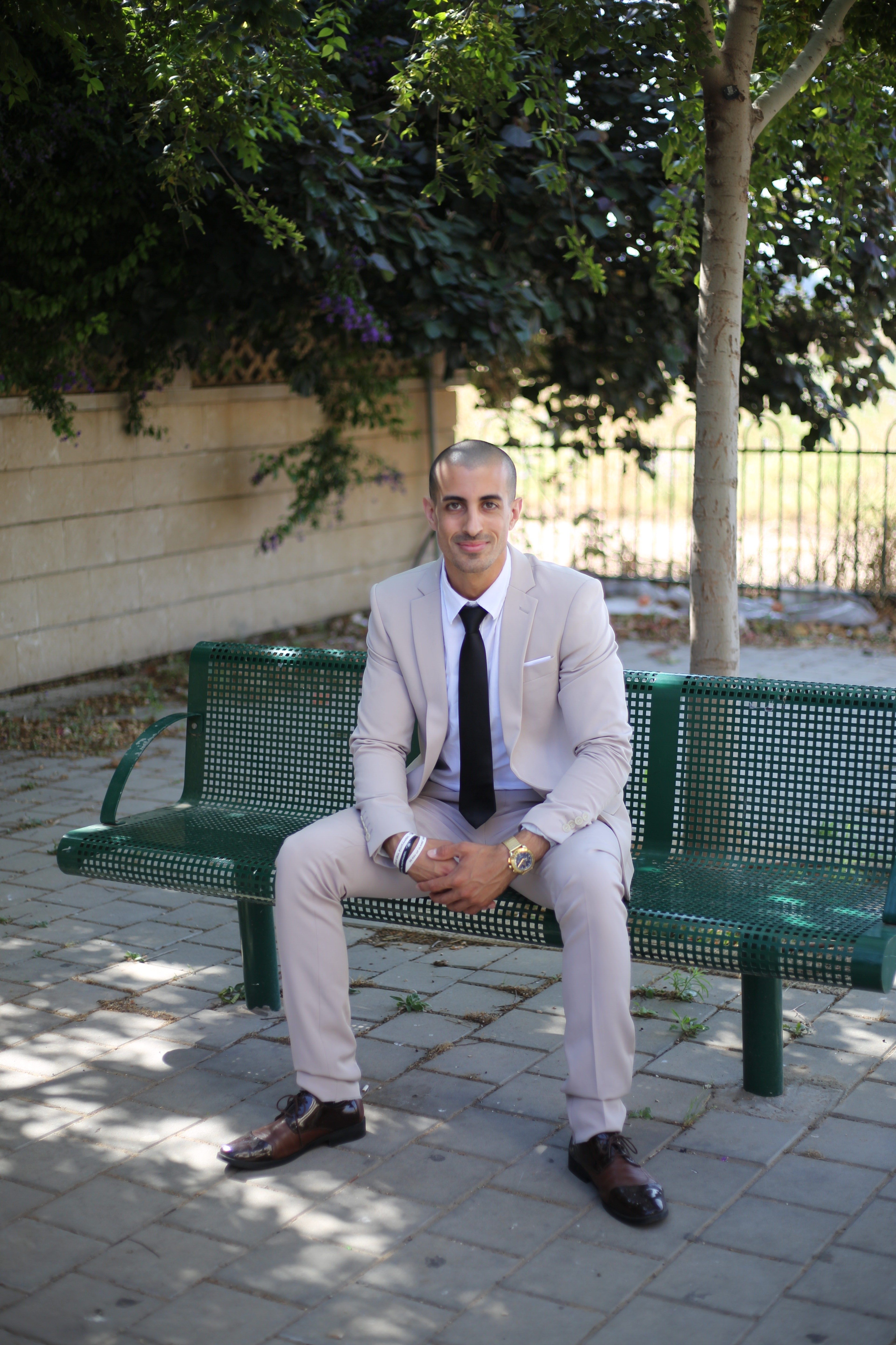 Professional man in a suit sitting on a park bench, contemplating business ideas.