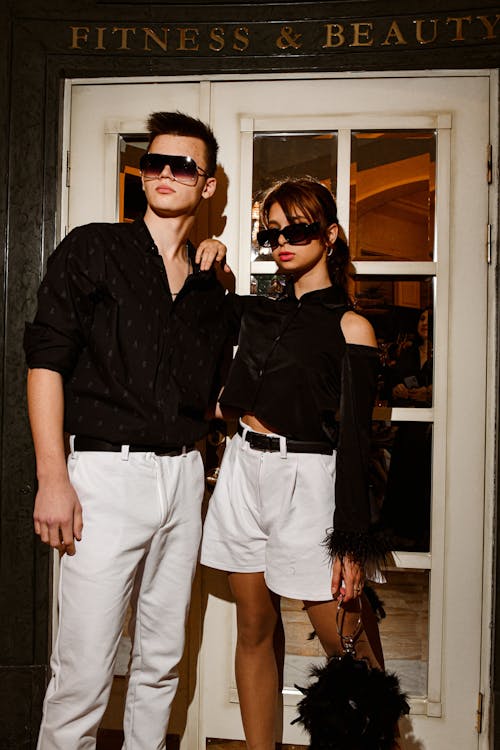 Free Man and Woman Posing in Black and White Clothes Stock Photo