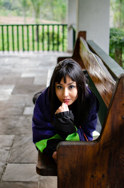 Black Haired Woman Posing on a Bench