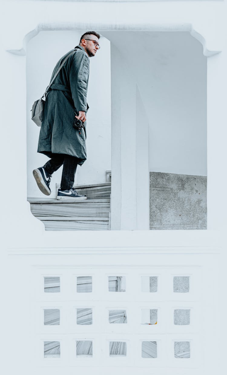 Man In Coat Walking Upstairs